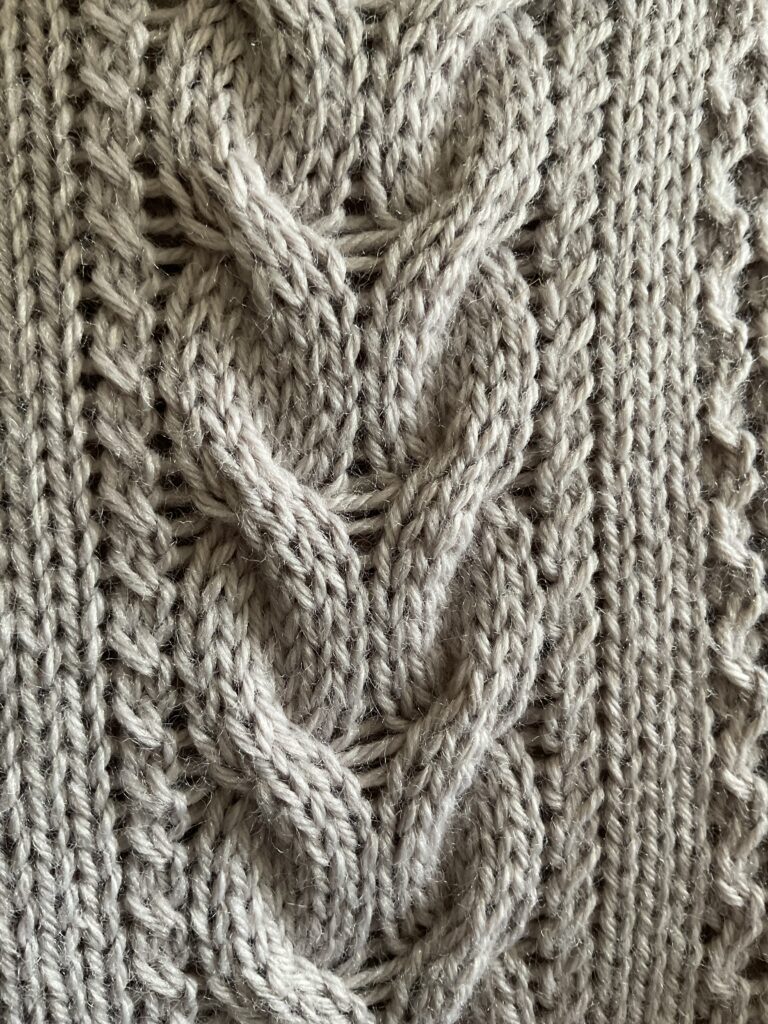 Image of centre cable panel of knitted biker style coatigan