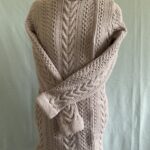 Ladies long line cardigan, with detailed aran stitches.