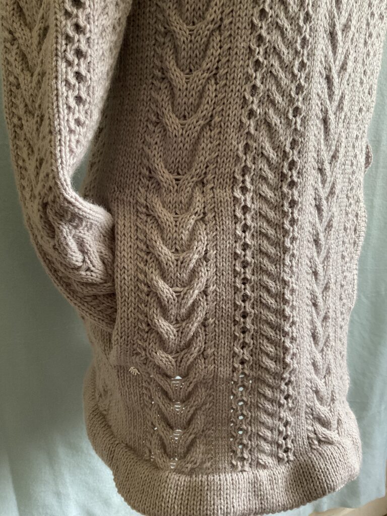 Close up of sleeve cuff in pockets of knitted ladies biker style coatigan 