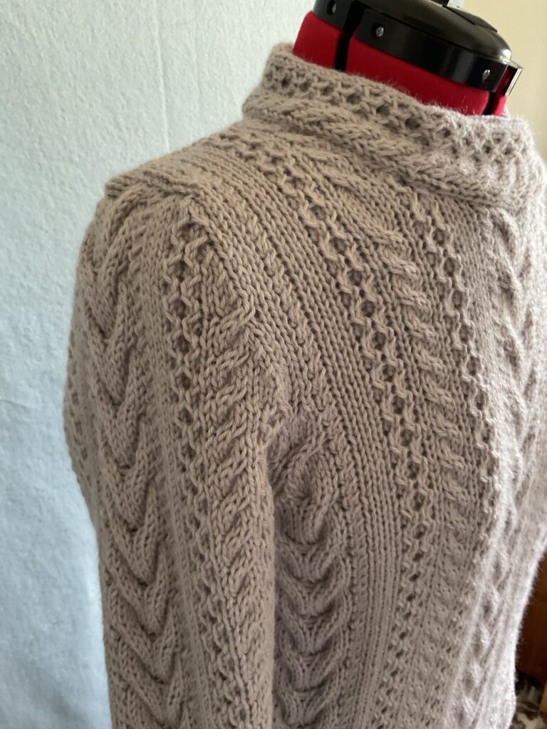 Close up image of various Aran stitches on biker style coatigan