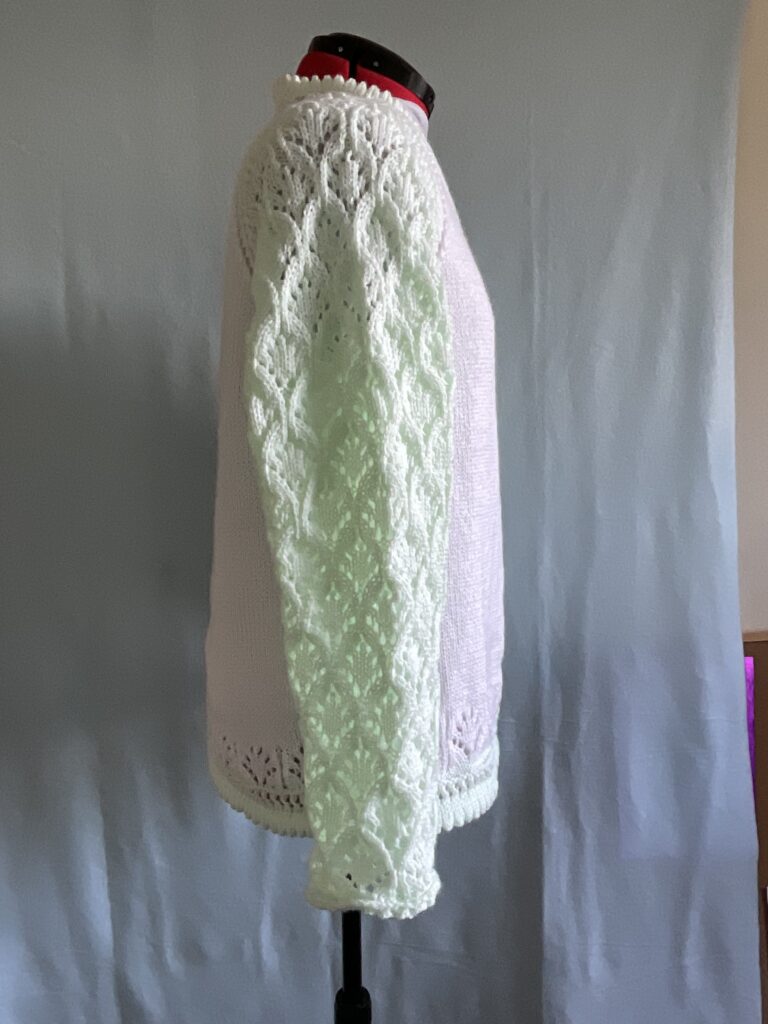 Side view of lace sleeves of ladies knitted cardigan