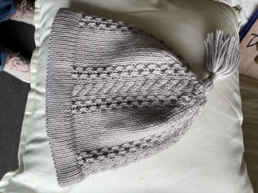 Image of knitted beanie with cable panel